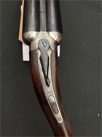A COGSWELL & HARRISON 12 BORE SHOTGUN WITH CROSS OVER STOCK